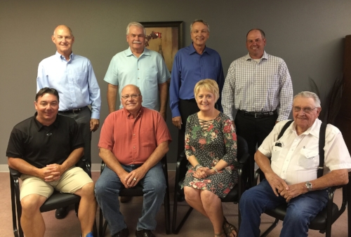 Aspire foundation board smiling while standing and sitting