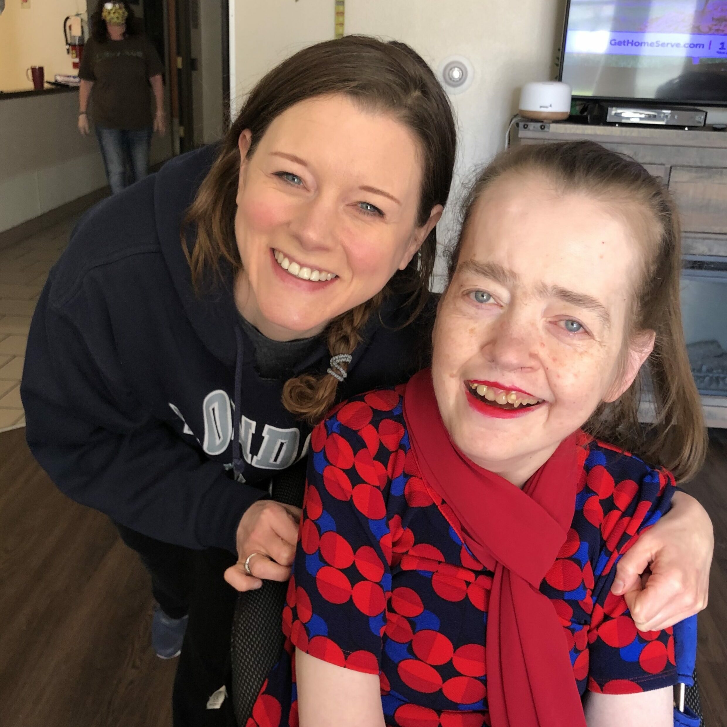 smiling female Aspire employee with happy female client inside