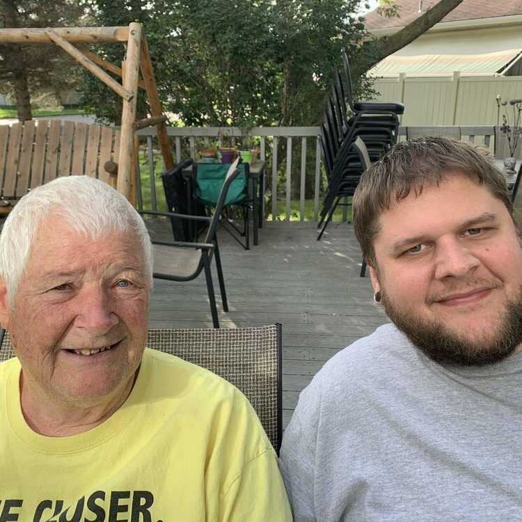 Aspire client and employee smiling outside on patio