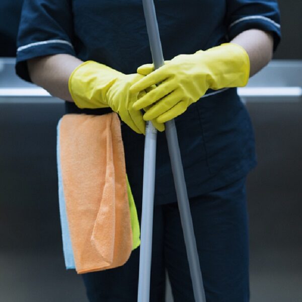 woman in the office with cleaning implements